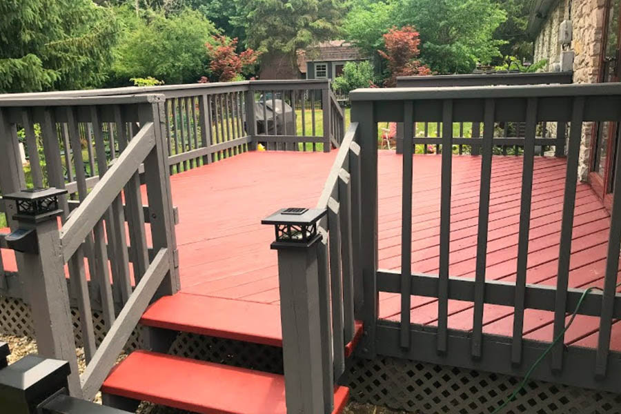 Deck with red painted flooring and gray rails