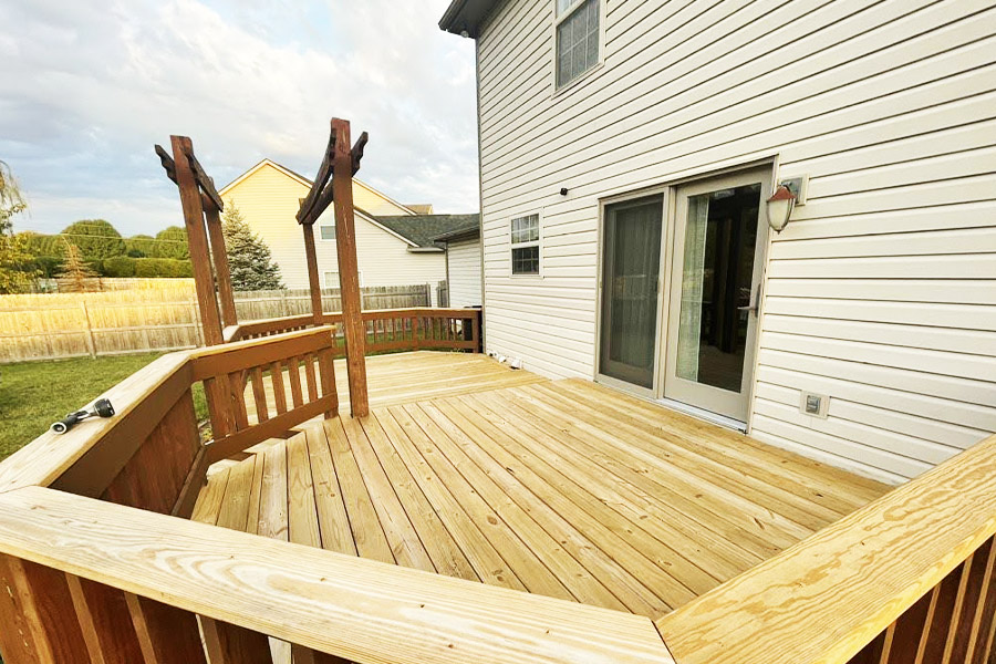 Freshly repaired and revitalized wooden deck by ONiT Carpentry, ready for Indianapolis backyards.